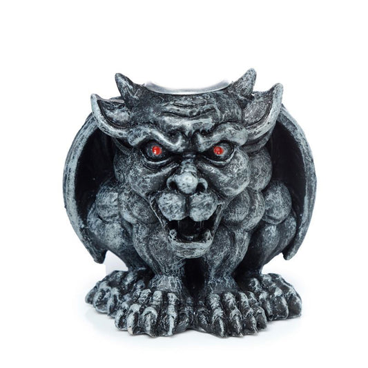 Gargoyle statue with red eyes on a white background