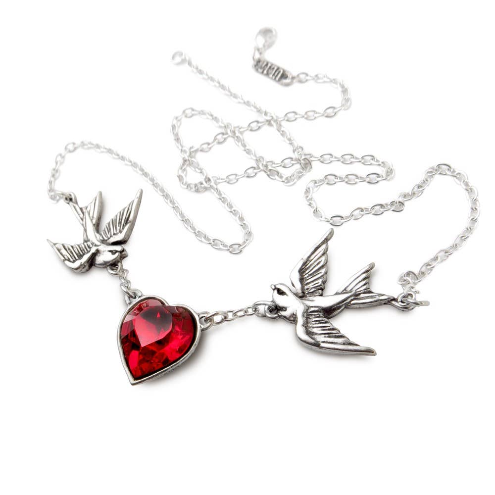 Necklace with red heart and silver bird pendants on a white background