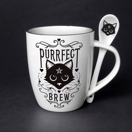 White mug with black cat design and 'Purrfect Brew' text, accompanied by a matching spoon on a dark background.