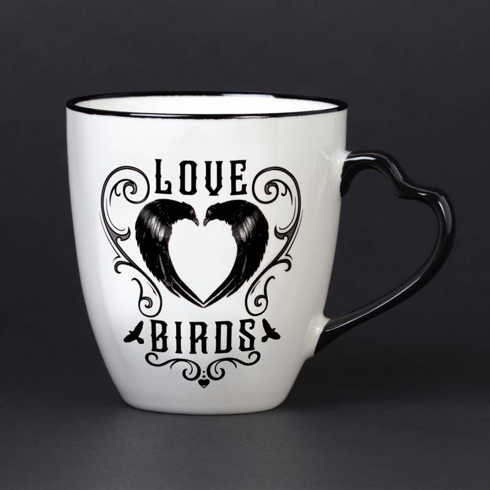 White mug with black heart design and 'Love Birds' text on a dark background