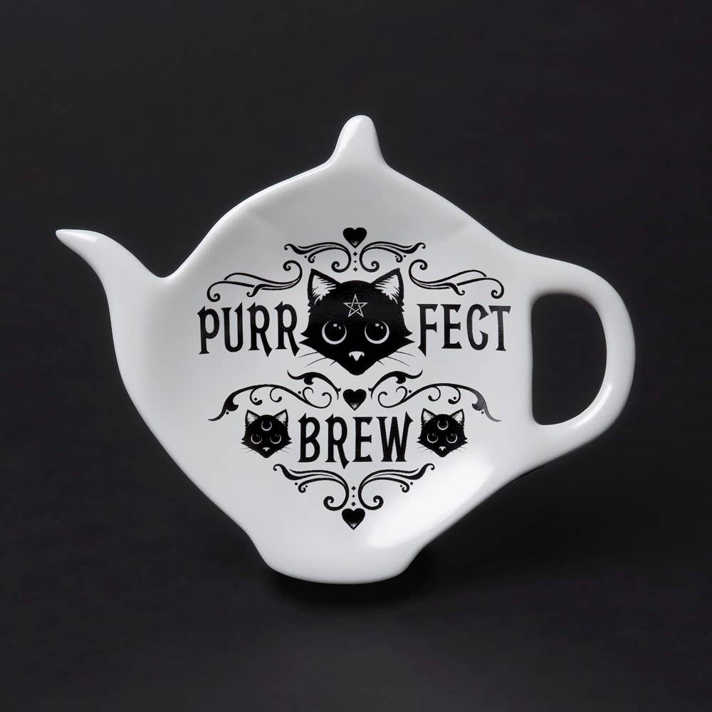 White teapot-shaped dish with black cat design and 'Purrfect Brew' text on a black background