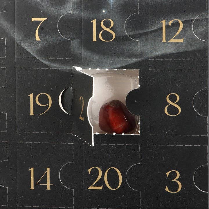Advent calendar with a red stone visible behind a numbered door, surrounded by gold numbers on a black background.