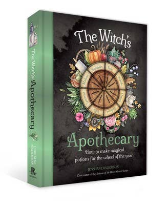 Book titled 'The Witch's Apothecary' with a decorative cover featuring a wheel design and herbs.