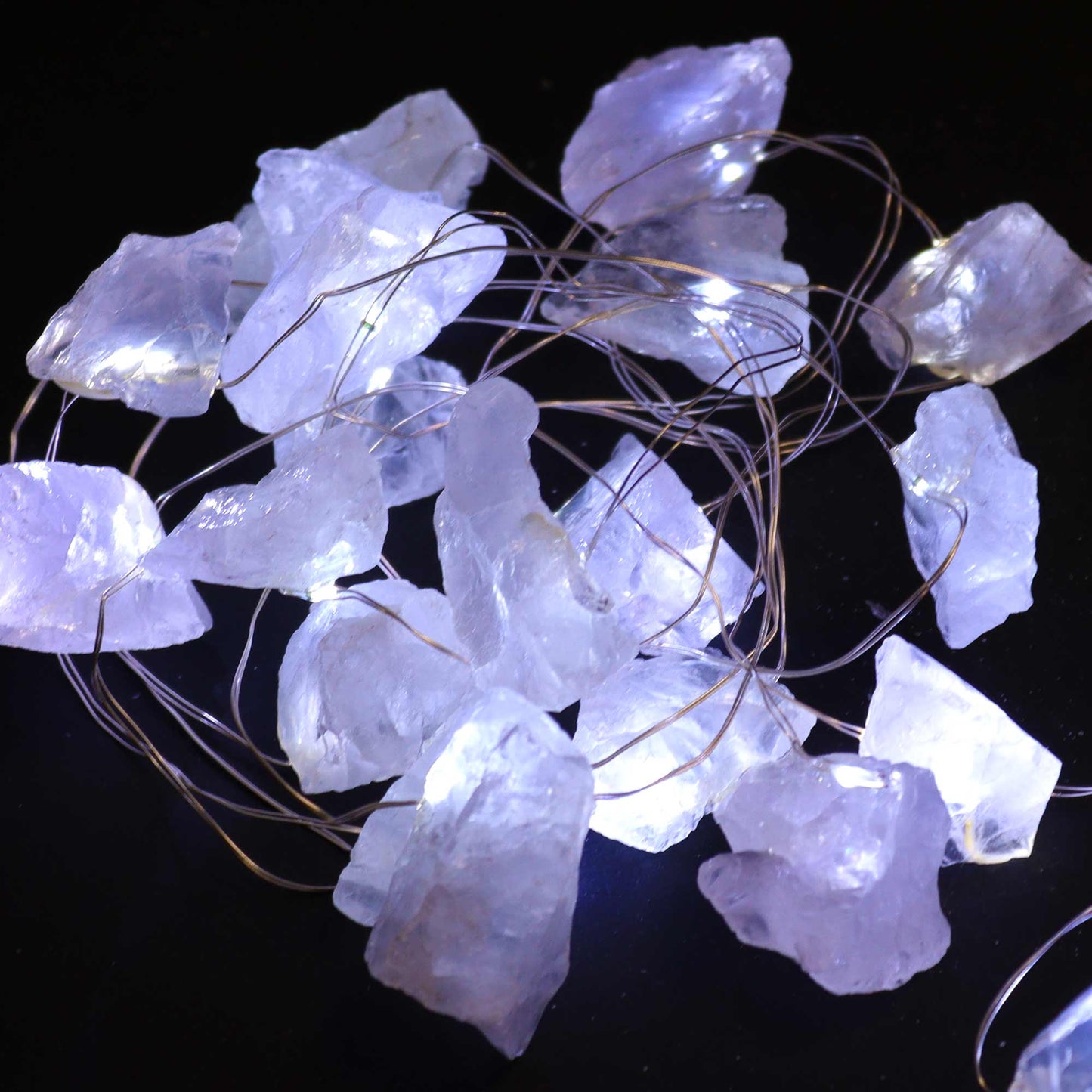 Rock Quartz gemstone lights lit up on a black background