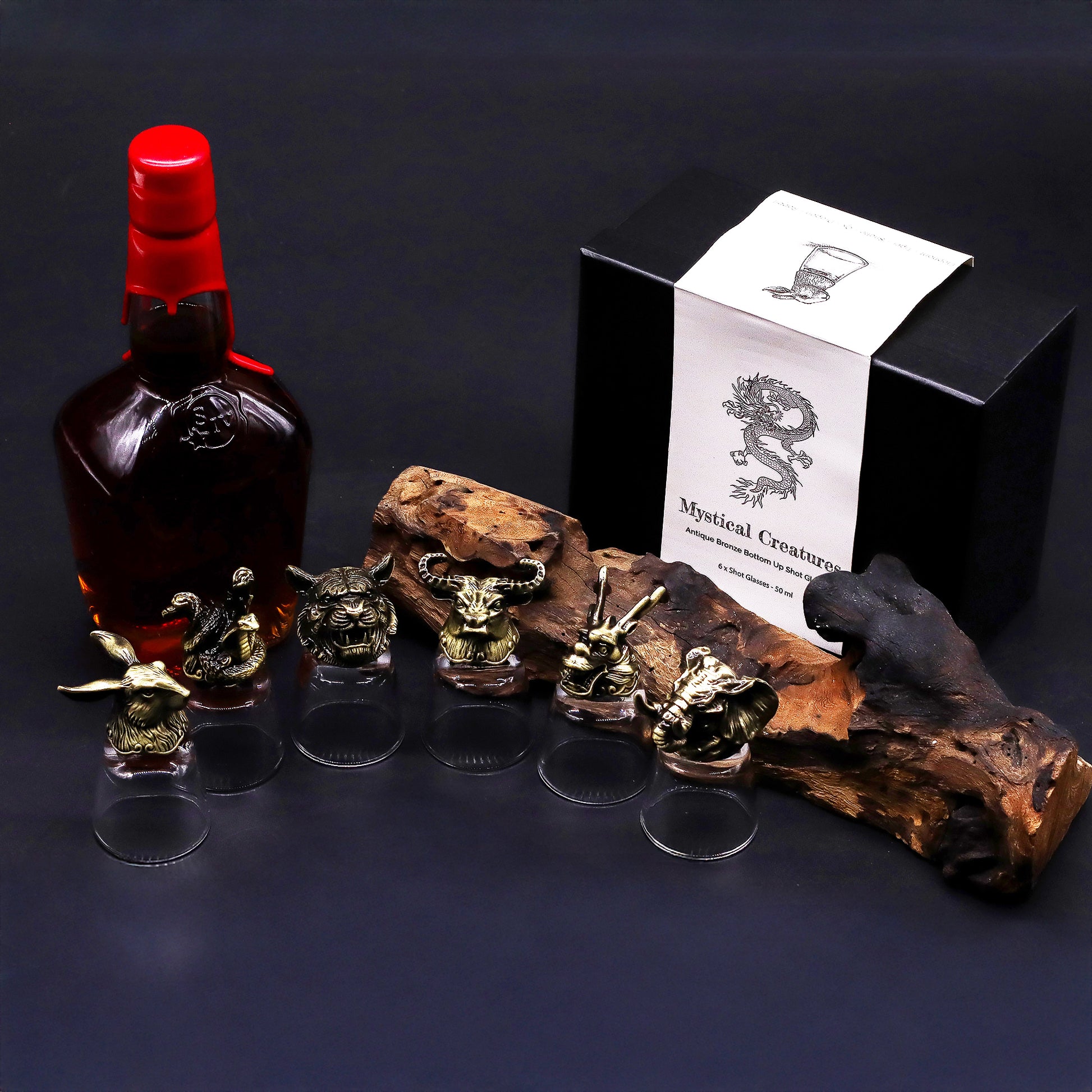 Six mystical creature shot glasses pictured with a bottle and gift box