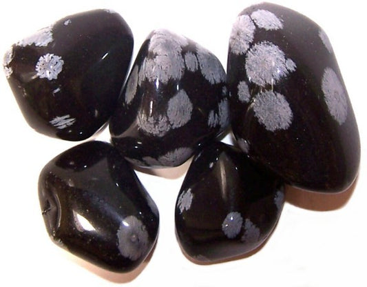 Black stones with white floral patterns on a white background