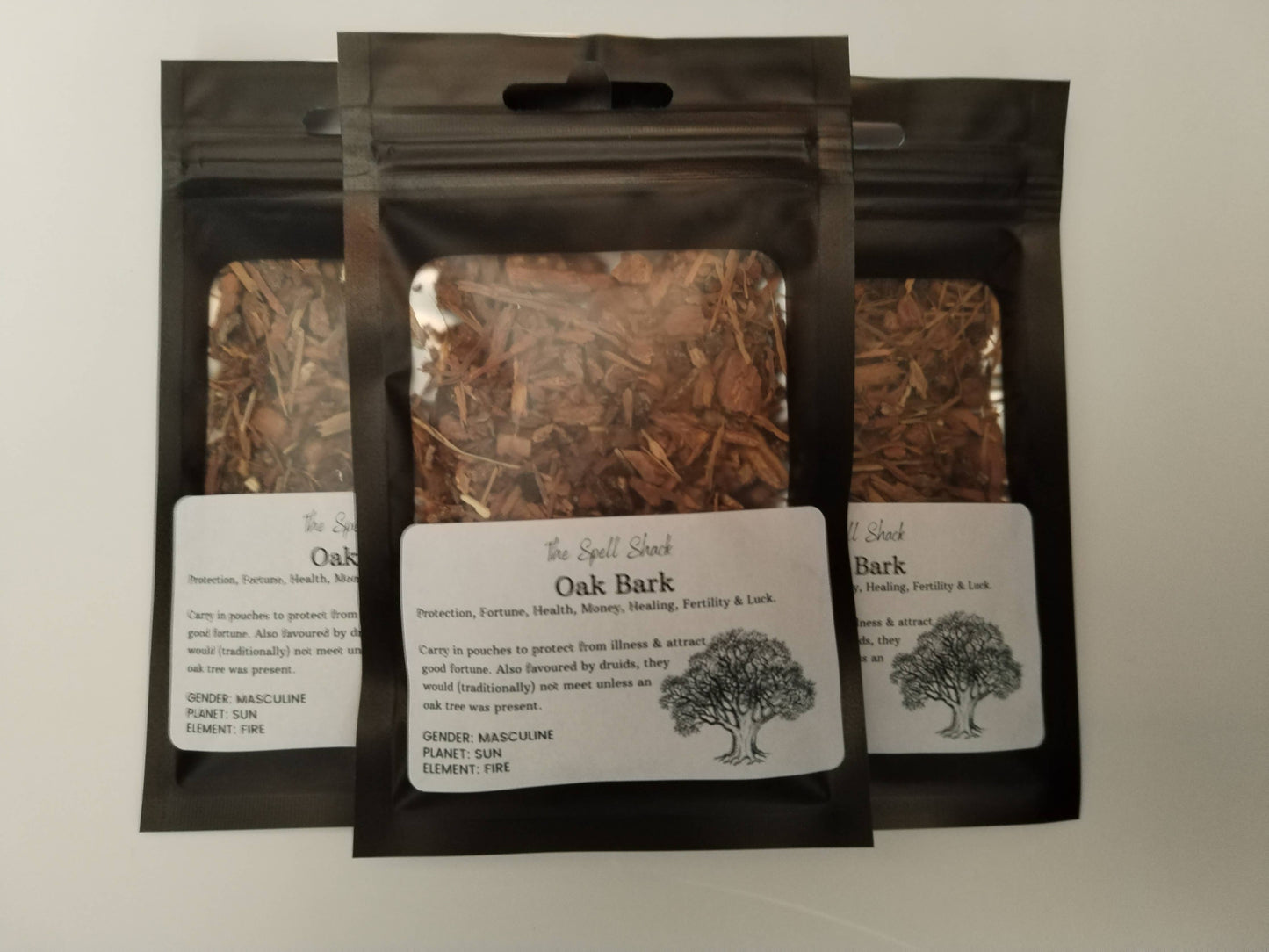 Three packages of Oak Bark with labels on a light background