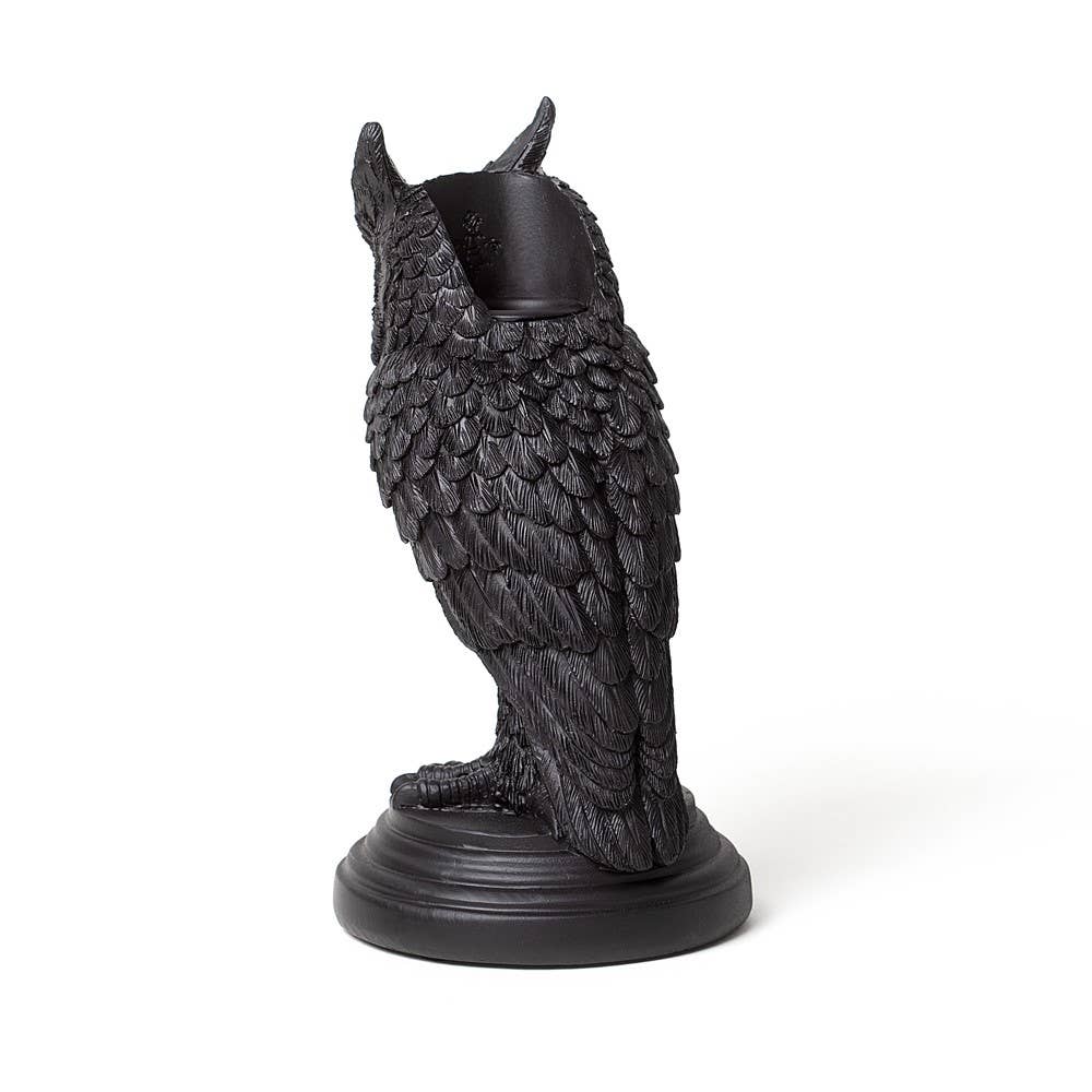 Black owl-shaped candle holder on a white background