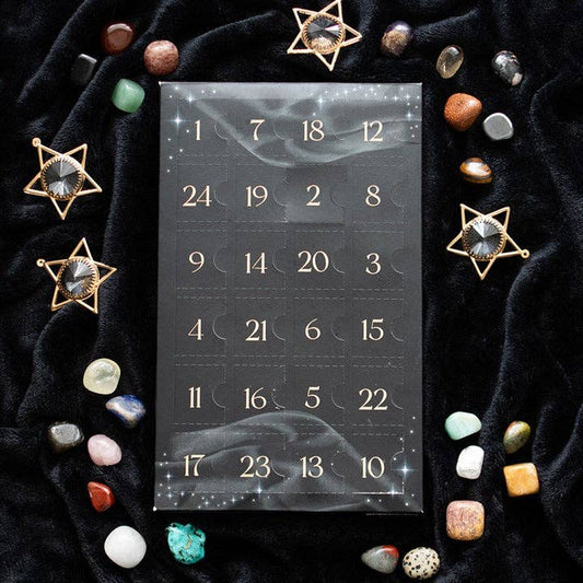 Calendar with decorative stones and crystals on a dark fabric background