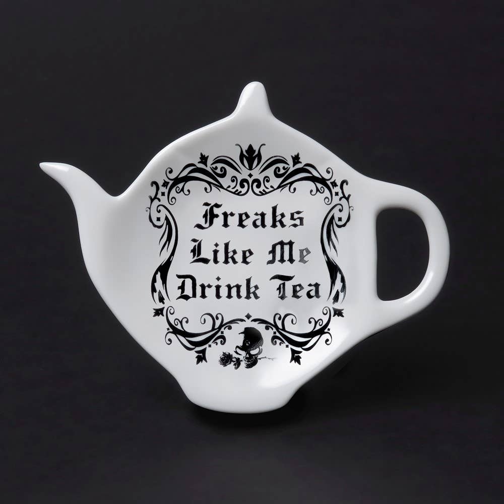 White teapot-shaped mug with black text and decorative elements on a black background