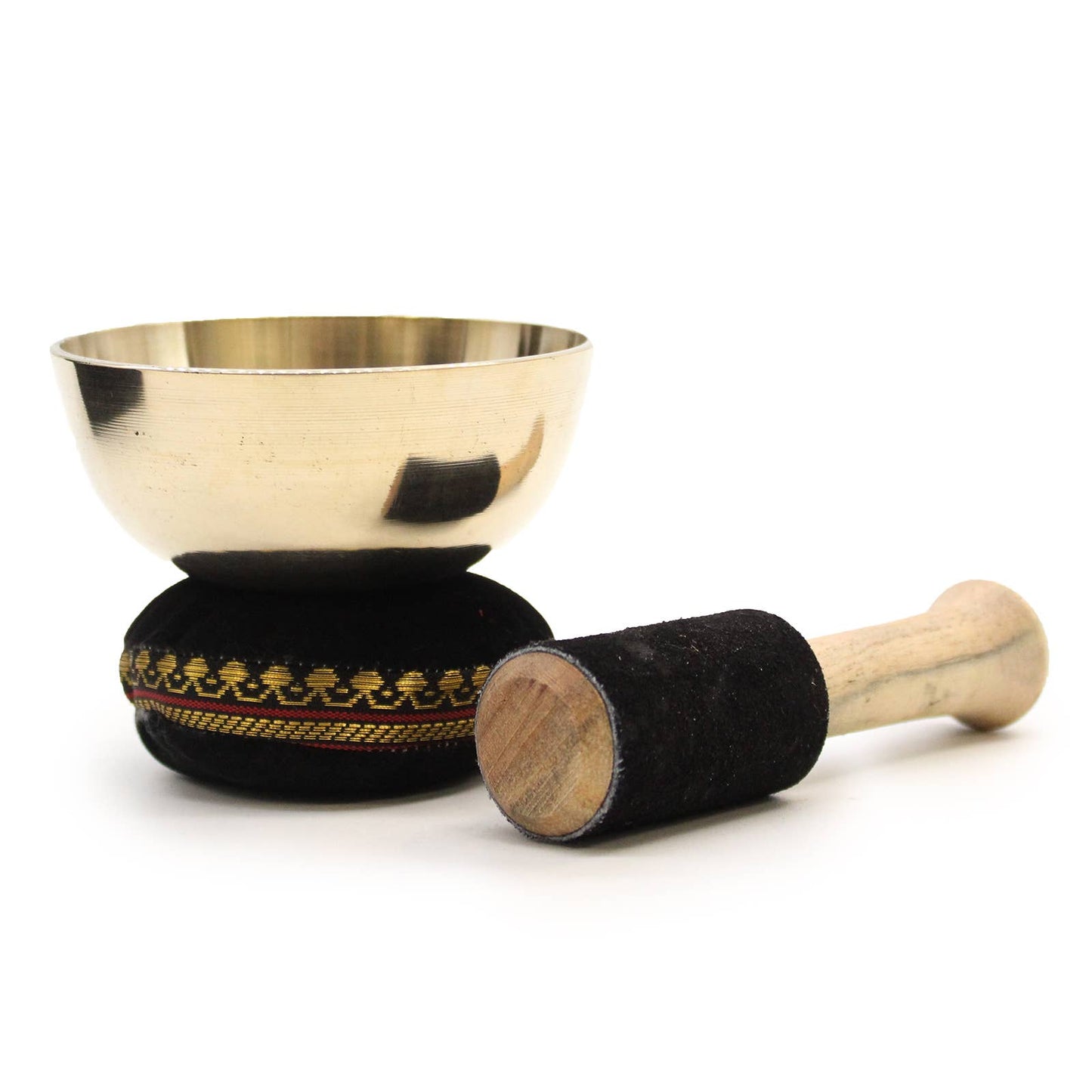 Brass singing bowl with black cushioned holder and wooden stick on a white background