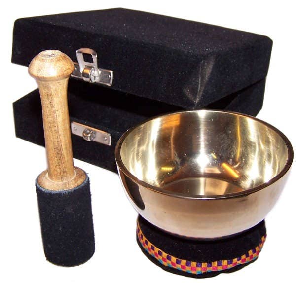 Tibetan singing bowl set with suede coated wooden stick and black carrying case on a white background