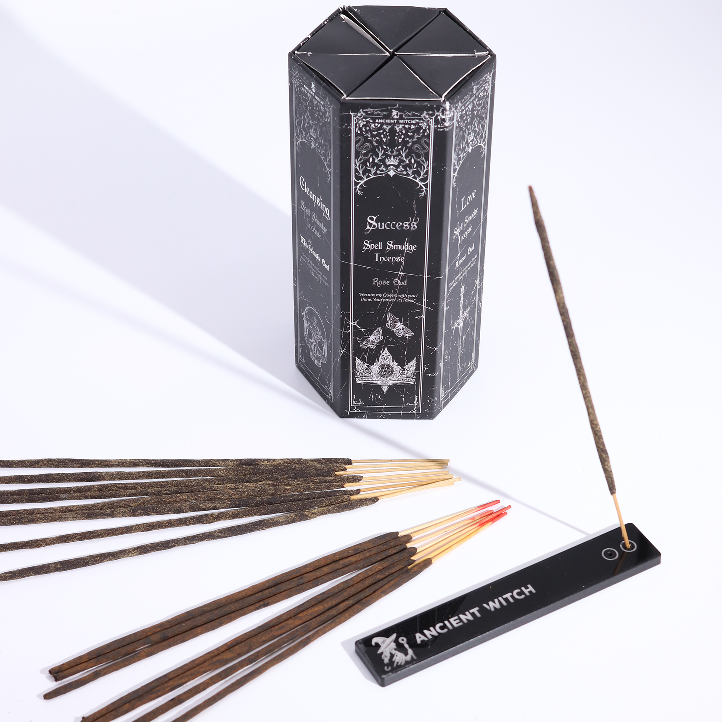 Spell smudge incense sticks beside a gift box with Ashcatcher on white background