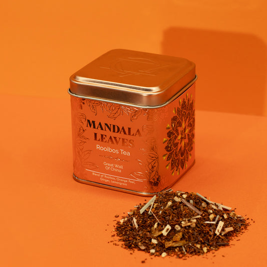 Great Wall of China rooibos  mandala leaves tea beside an orange and gold tin
