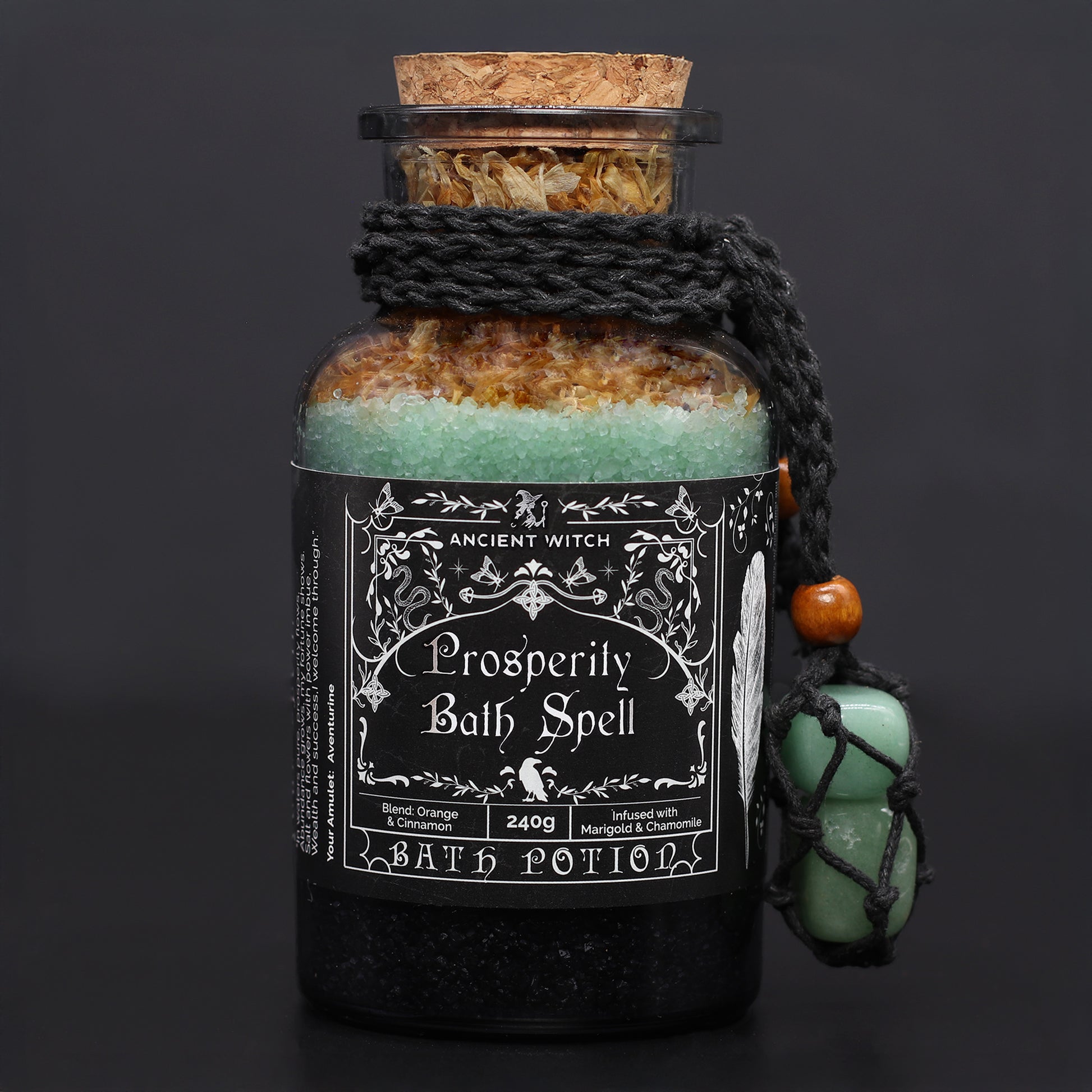 Bottle of 'Prosperity Bath Spell' bath potion with decorative label on a dark background