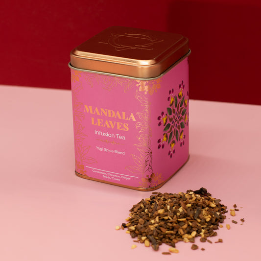 Yogi spice blend Mandala Leaves infusion tea beside a pink and gold tin
