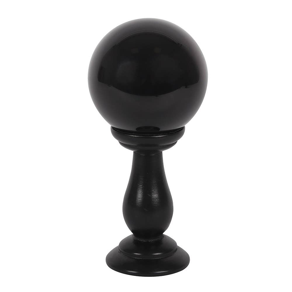 Black spherical object on a stand against a white background