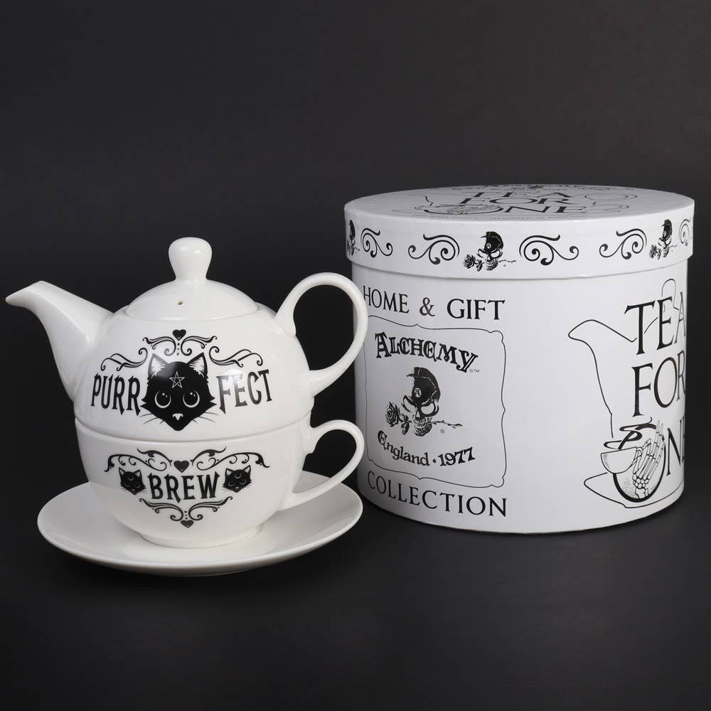 Teapot with 'Purr Fect Brew' text, saucer, and decorative box on a black background