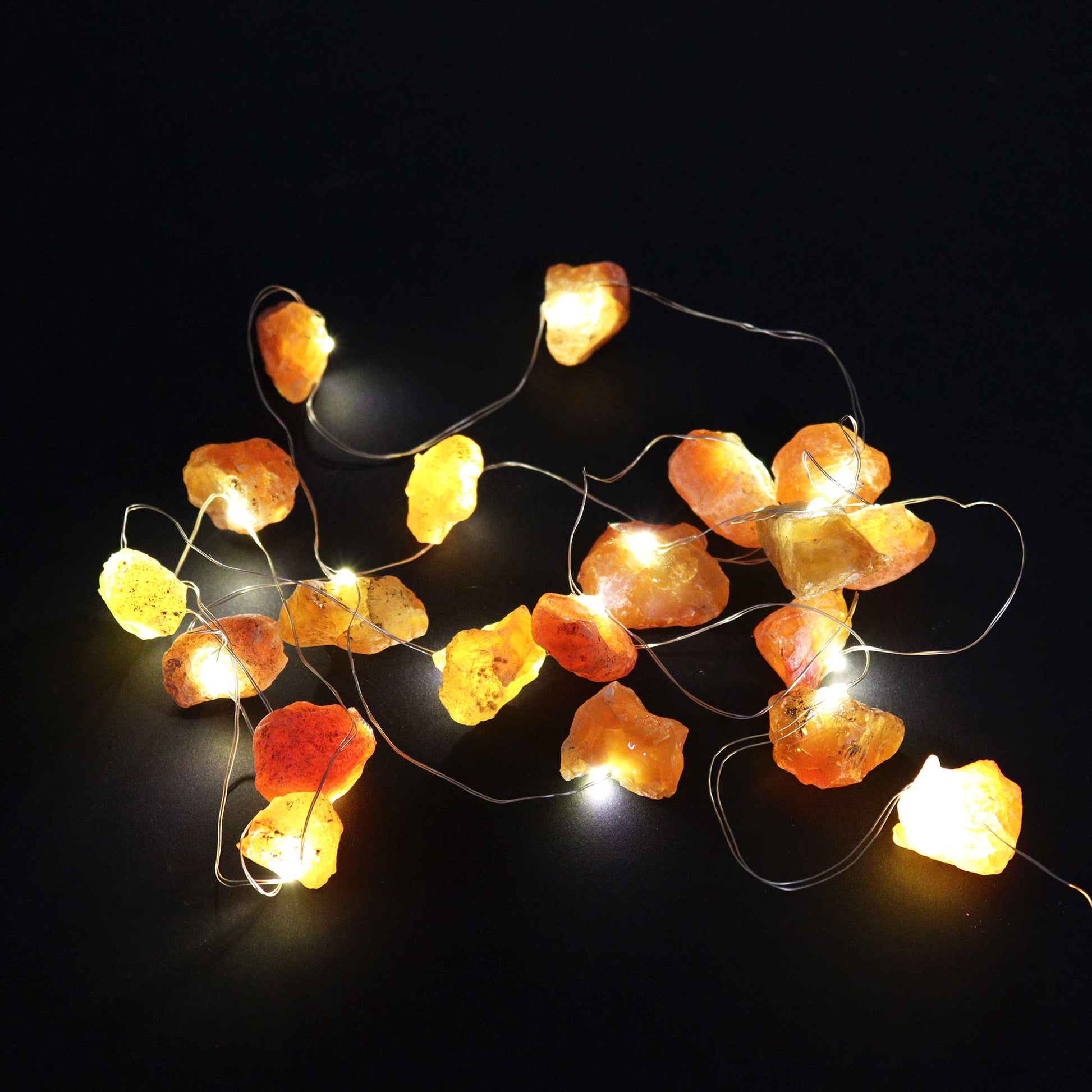 Orange jade gemstone lights lit up on a black background