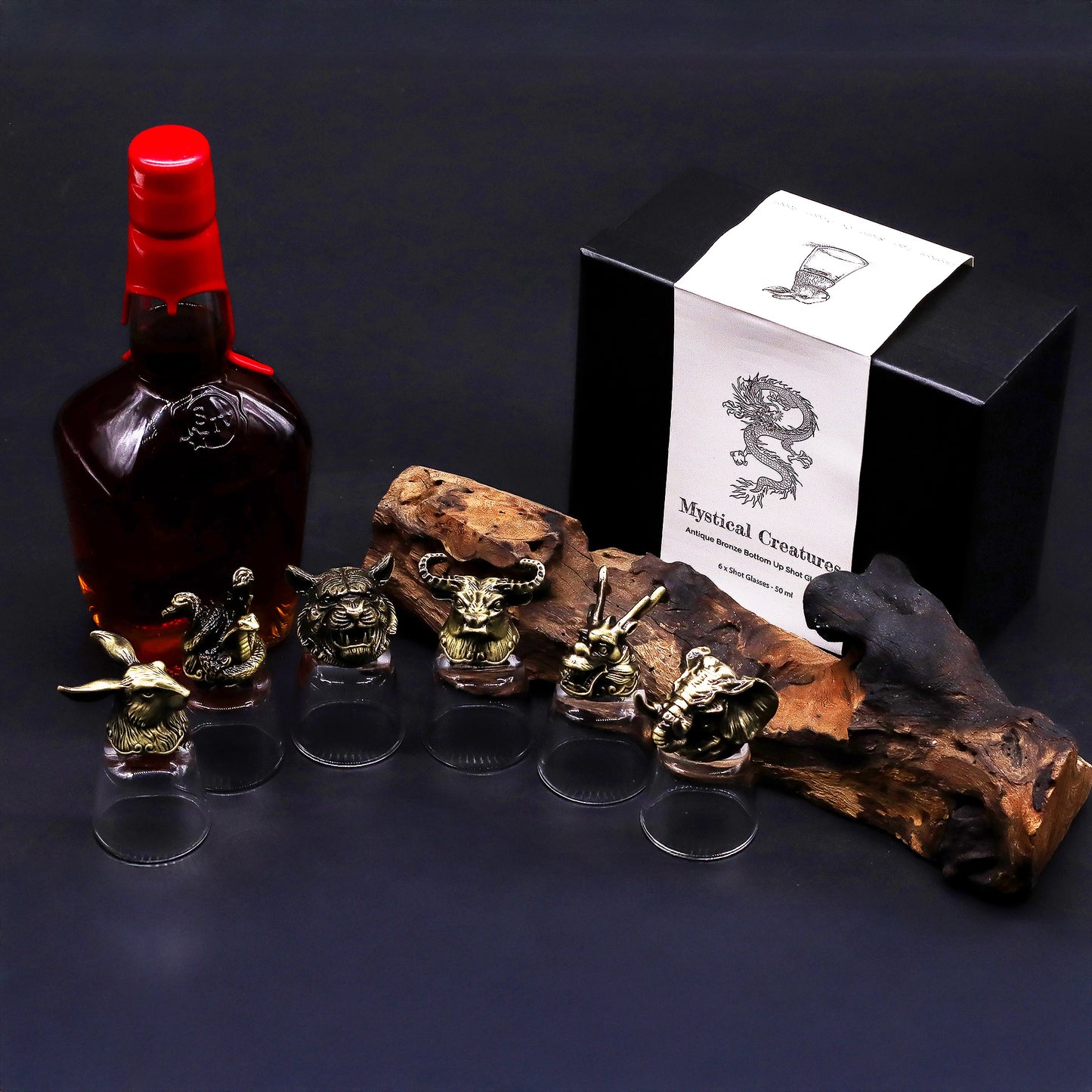 Six mystical creature shot glasses pictured with a bottle and gift box