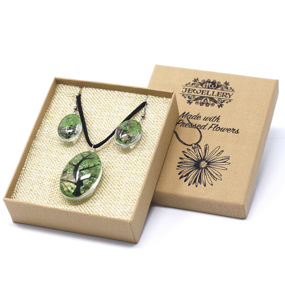 Jewelry set with green tree design in a brown box labeled 'Jewellery Made with Pressed Flowers'.