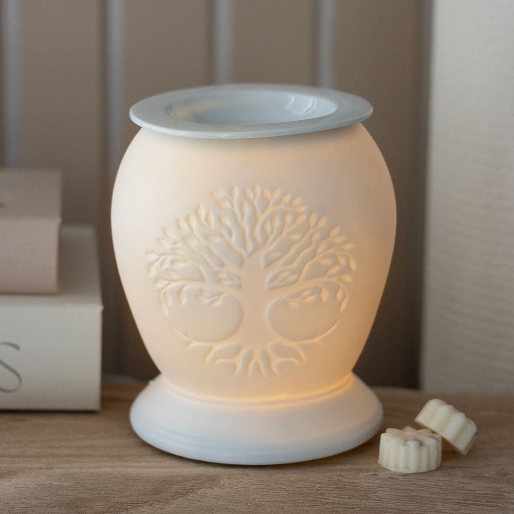white ceramic wax melt burner on wooden stand with books in background